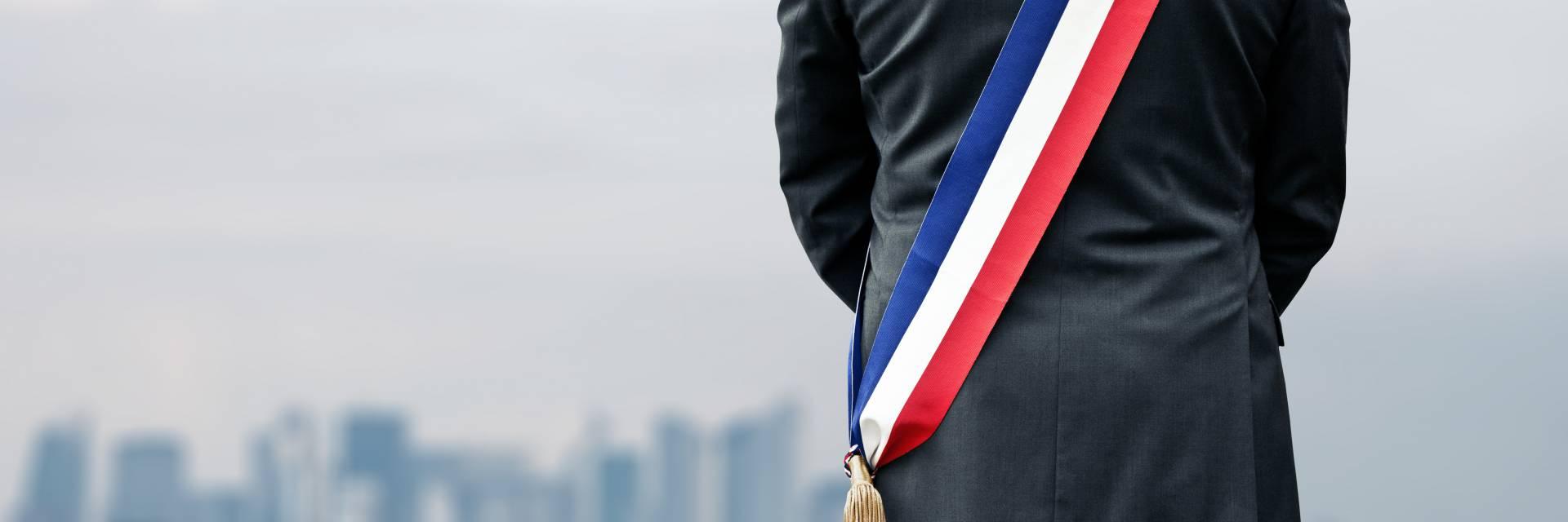 Un élu portant son écharpe de maire, assuré avec l'Assurance Personnelle de l'Élu(e) GMF
