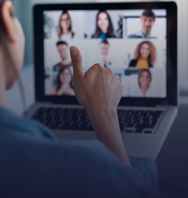 Femme d'affaires participant à un appel vidéo tout en étant assise sur un canapé à la maison.