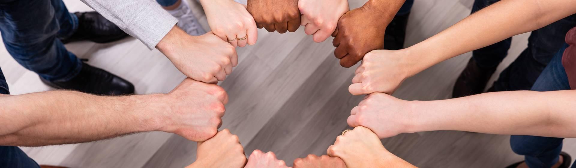 People Hands Joining Their Fist To Form Circle